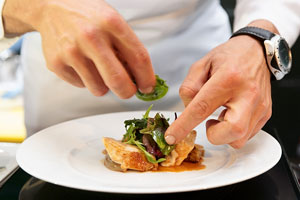 culinary arts - chef decorating an appetizer plate