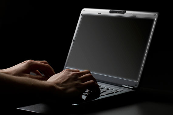 hands typing on a laptop computer keyboard