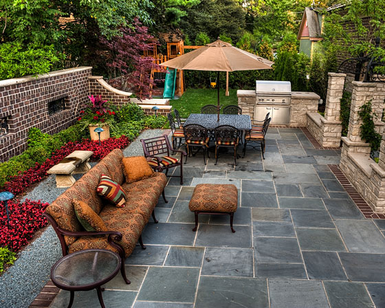 backyard patio, with built-in gas grill and adjacent swing set