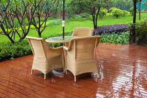 wicker furniture on a ground-level wooden deck